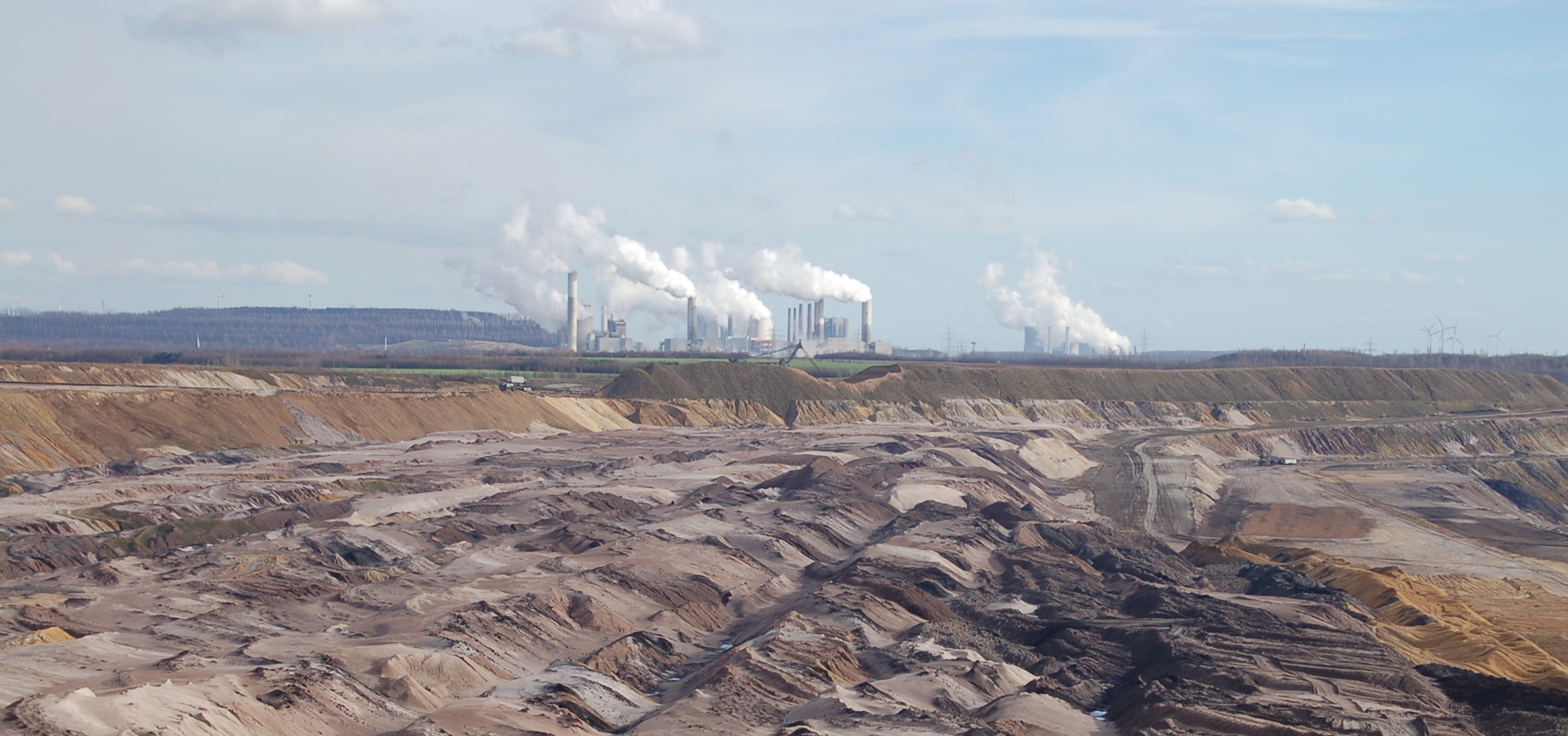 view of lignite lining fields with coal plant in the background