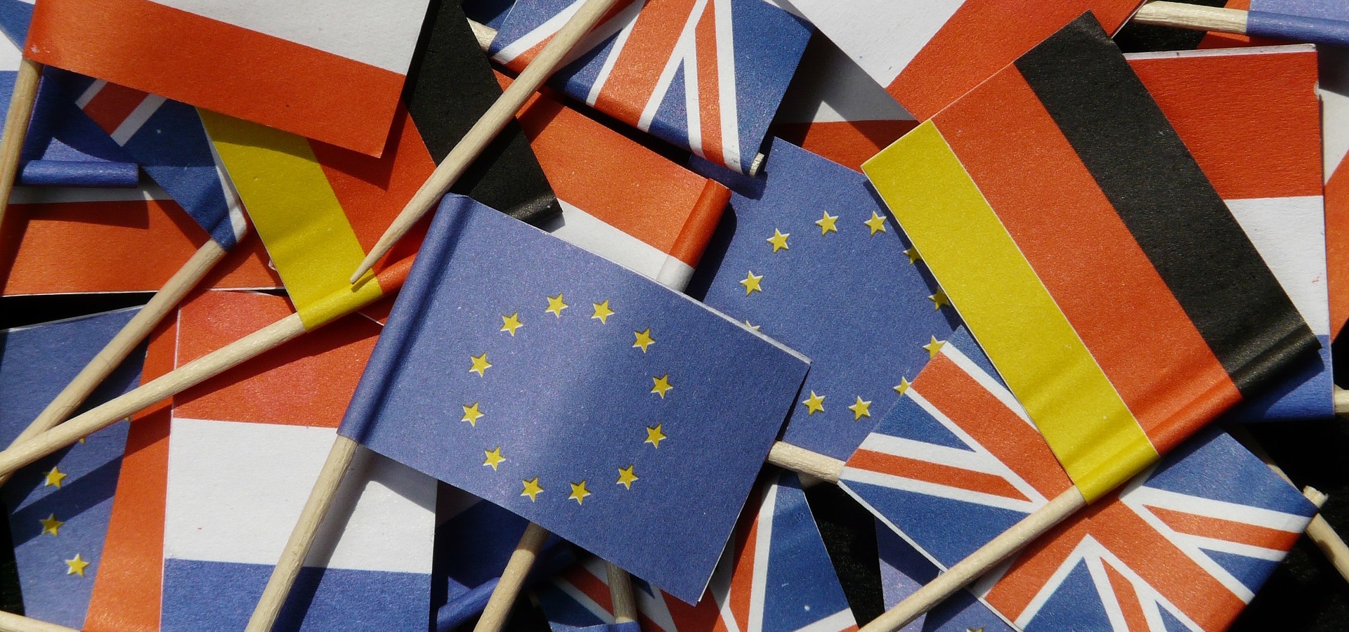 A pile of small paper flags from the EU, Germany, France and the UK