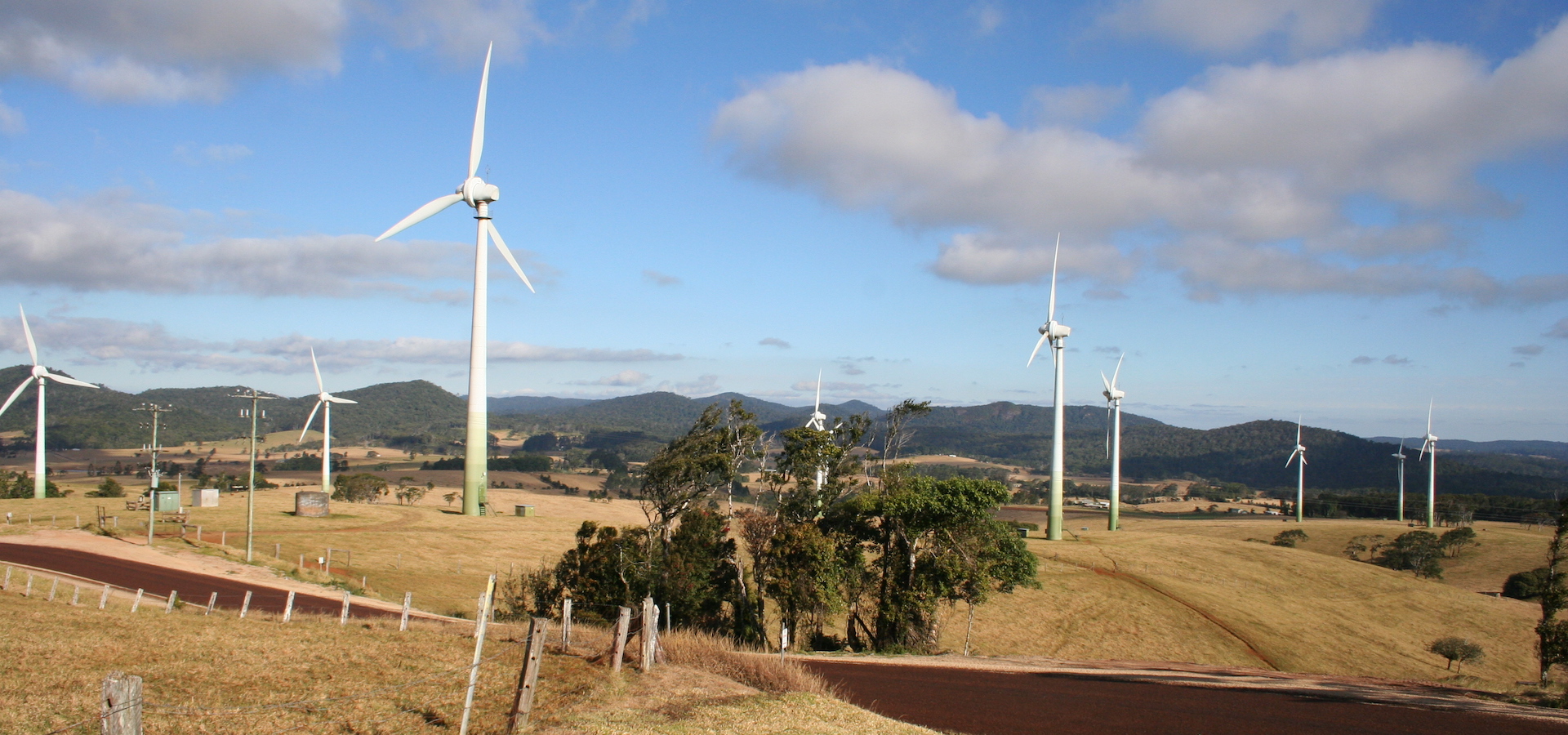 wind farm in Australia with mountains in the background